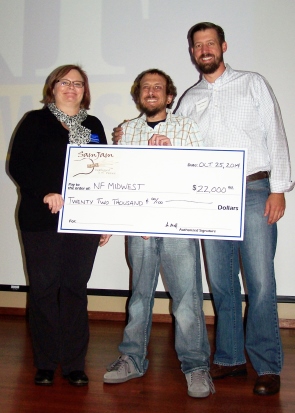 Sam Oswald and his brother, Peter Oswald, presented a check for $22,000 to Diana Haberkamp, Executive Director of Neurofibromatososis (NF) Midwest, at the 24th Annual NF Symposium in Hoffman Estates on October 25. 